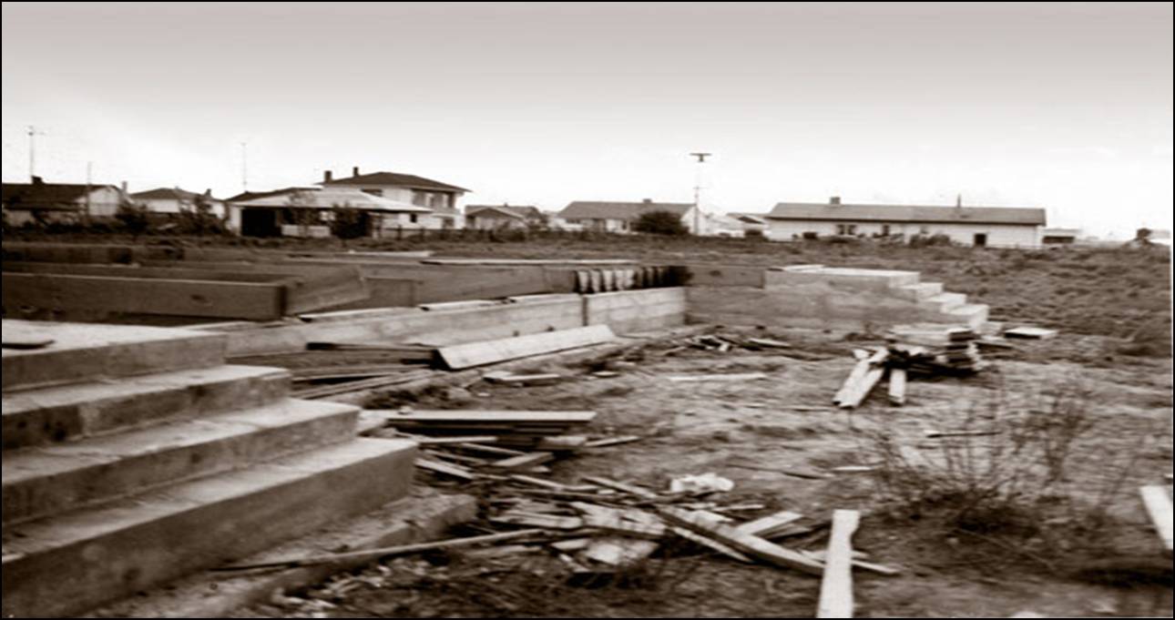 Historic black and white photograph of the initial construction phase in 1955, showing the foundation excavation and wooden formwork for Trinity Lutheran Church’s first parish hall in Richmond.